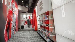 Arkansas State University Football Opps inside Barber shop with glass display case and graphics printed on walls